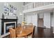 An elegant dining room featuring a dark wood table, a fireplace, and an open floor plan at 15936 Symphony Blvd, Noblesville, IN 46060