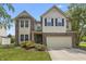 Charming home with brick and siding, a two-car garage, a manicured lawn, and colorful landscaping at 15936 Symphony Blvd, Noblesville, IN 46060