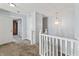 Upstairs hallway with plush carpet, neutral paint, a pendant light, and access to multiple rooms at 15936 Symphony Blvd, Noblesville, IN 46060