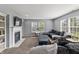 A living room with a cozy fireplace, a comfortable seating area, and plenty of natural light at 15936 Symphony Blvd, Noblesville, IN 46060