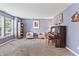 A formal living room is painted purple and features neutral carpet, light furniture, and a piano at 15936 Symphony Blvd, Noblesville, IN 46060