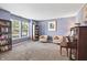 Comfortable living room with cozy seating, filled bookshelves, and a classic piano for musical enjoyment at 15936 Symphony Blvd, Noblesville, IN 46060