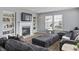 A living room with a cozy fireplace, comfortable seating, and built-in bookshelves providing lots of storage at 15936 Symphony Blvd, Noblesville, IN 46060