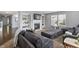 A comfortable living room with large sofa, a fireplace with built-in shelves, and natural light from the windows at 15936 Symphony Blvd, Noblesville, IN 46060