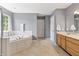Large ensuite bathroom with a jacuzzi tub, a large window, and a double sink vanity at 15936 Symphony Blvd, Noblesville, IN 46060