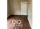 This bedroom features wood-look floors and a white door at 1602 E Minnesota St, Indianapolis, IN 46203