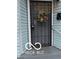 Secured front door adorned with a festive wreath, providing a charming welcome and security features at 1602 E Minnesota St, Indianapolis, IN 46203