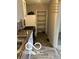 Functional kitchen space equipped with a range, refrigerator, and ample shelving; ready for updates at 1602 E Minnesota St, Indianapolis, IN 46203