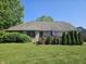 This landscaped backyard with green grass and mature trees offers a peaceful retreat at 1605 Fox Dr, Martinsville, IN 46151