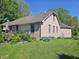 Spacious backyard featuring a well-maintained lawn, a deck, and beautiful landscaping at 1605 Fox Dr, Martinsville, IN 46151