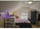 This bedroom has a sloped ceiling, window, and playful decor at 1605 Fox Dr, Martinsville, IN 46151