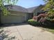Charming brick home featuring an attached garage and lush landscaping at 1605 Fox Dr, Martinsville, IN 46151