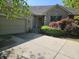 Charming brick home featuring an attached garage and lush landscaping at 1605 Fox Dr, Martinsville, IN 46151