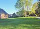 Brick home with a lush green lawn and mature trees, set in a peaceful neighborhood at 1605 Fox Dr, Martinsville, IN 46151