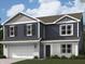 Charming two-story home showcases blue siding, white brick accents, and a well-manicured lawn at 1606 Trichel Dr, Greenwood, IN 46143