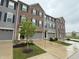 A row of three-story townhouses featuring brick and gray siding with well-maintained landscaping at 17364 Graley Pl, Westfield, IN 46074