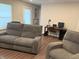 Cozy living room with reclining sofa and chair, a desk area and wood-look floors at 17364 Graley Pl, Westfield, IN 46074