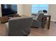 Living room features comfortable seating, a mounted television and wood flooring at 17364 Graley Pl, Westfield, IN 46074