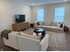 A bright living room with neutral walls, a large sectional sofa, and a contemporary media center at 17364 Graley Pl, Westfield, IN 46074