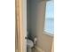 Toilet with a roll of toilet paper, near the window, and next to shower at 17364 Graley Pl, Westfield, IN 46074