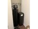 Modern black water softener system against a white wall on dark wood floors at 17364 Graley Pl, Westfield, IN 46074