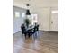 Modern dining room features a glass table, black chairs, stylish wallpaper, and natural light from the window at 214 Handley St, Indianapolis, IN 46222