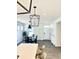 Open-concept dining room features modern lighting, neutral decor, and seamless flow to the entryway and kitchen at 214 Handley St, Indianapolis, IN 46222