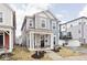 Attractive two-story home featuring a welcoming front porch, complemented by stylish blue and gray exterior paint at 214 Handley St, Indianapolis, IN 46222