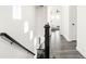 Bright hallway features hardwood floors, a black staircase, and a view of the bedroom at 214 Handley St, Indianapolis, IN 46222