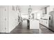 Open kitchen flows seamlessly into the living area, featuring modern appliances and island seating at 214 Handley St, Indianapolis, IN 46222