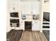 Modern kitchen with white cabinets, stainless appliances, wine cooler and coffee machine at 214 Handley St, Indianapolis, IN 46222