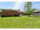 Brick home with a fenced-in yard with mature trees at 2220 Radcliffe Ave, Indianapolis, IN 46227