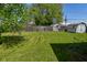 A large backyard features a shed, wooden fence, and mature trees at 2220 Radcliffe Ave, Indianapolis, IN 46227
