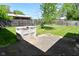 A spacious backyard featuring a concrete patio, storage container, and wooden fence at 2220 Radcliffe Ave, Indianapolis, IN 46227