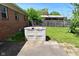 A spacious backyard featuring a concrete patio, storage container, and wooden fence at 2220 Radcliffe Ave, Indianapolis, IN 46227