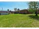 View of a grass backyard with a shed and a brick home at 2220 Radcliffe Ave, Indianapolis, IN 46227