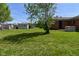 A grassy backyard featuring a shed, wooden fence, and mature trees at 2220 Radcliffe Ave, Indianapolis, IN 46227