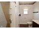Standard fixtures, window, and full shower stall in this bathroom at 2220 Radcliffe Ave, Indianapolis, IN 46227