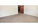 Neutral-toned bedroom with carpet flooring and an open doorway to an adjacent room at 2220 Radcliffe Ave, Indianapolis, IN 46227