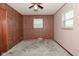 Bedroom featuring paneled wall, two windows, ceiling fan and carpeted floor at 2220 Radcliffe Ave, Indianapolis, IN 46227