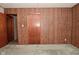 Bedroom featuring paneled wall, carpeted floor, and two closets at 2220 Radcliffe Ave, Indianapolis, IN 46227