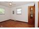 This bedroom features hardwood floors, white walls, natural light, and an open closet for storage at 2220 Radcliffe Ave, Indianapolis, IN 46227