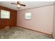 Bedroom featuring paneled wall, two windows, ceiling fan and carpeted floor at 2220 Radcliffe Ave, Indianapolis, IN 46227