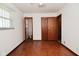 This bedroom features hardwood floors, white walls, natural light, and a standard closet at 2220 Radcliffe Ave, Indianapolis, IN 46227
