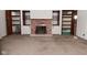 Living room with a brick fireplace and built in shelving at 2220 Radcliffe Ave, Indianapolis, IN 46227