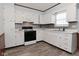 Bright kitchen featuring ample cabinet space, updated appliances, and laminate backsplash at 2220 Radcliffe Ave, Indianapolis, IN 46227