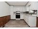 Traditional-style kitchen featuring white cabinetry, stainless steel appliances, and durable flooring at 2220 Radcliffe Ave, Indianapolis, IN 46227