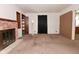 Living room with a brick fireplace, doorway to exterior and doorways to other rooms at 2220 Radcliffe Ave, Indianapolis, IN 46227