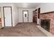 Living room with a brick fireplace and doorway to exterior at 2220 Radcliffe Ave, Indianapolis, IN 46227