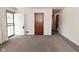 Neutral living room with carpet, white walls, and an open doorway to the outside at 2220 Radcliffe Ave, Indianapolis, IN 46227